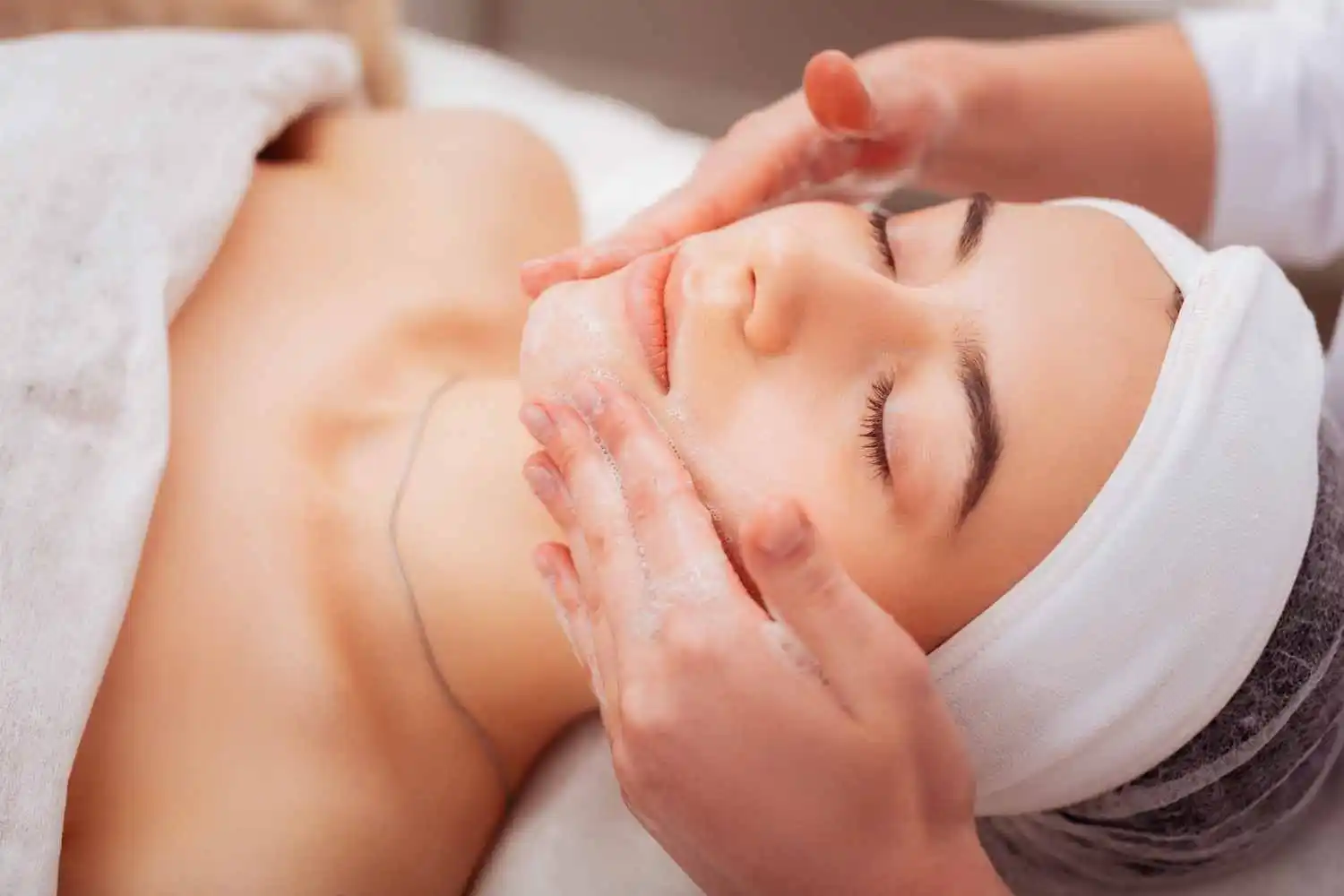 Woman receiving a professional facial treatment for skin rejuvenation